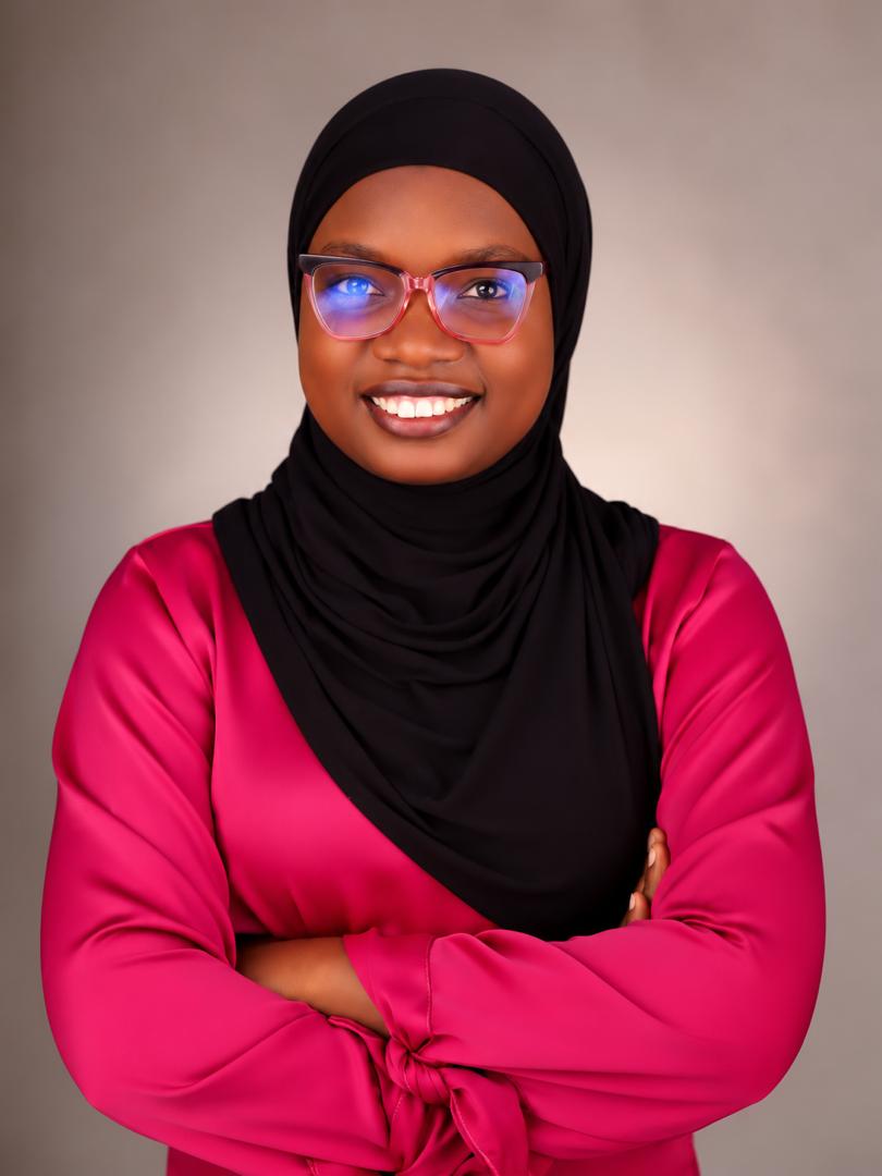 Portrait of Rafiat Bamimore wearing glasses and a pink blouse